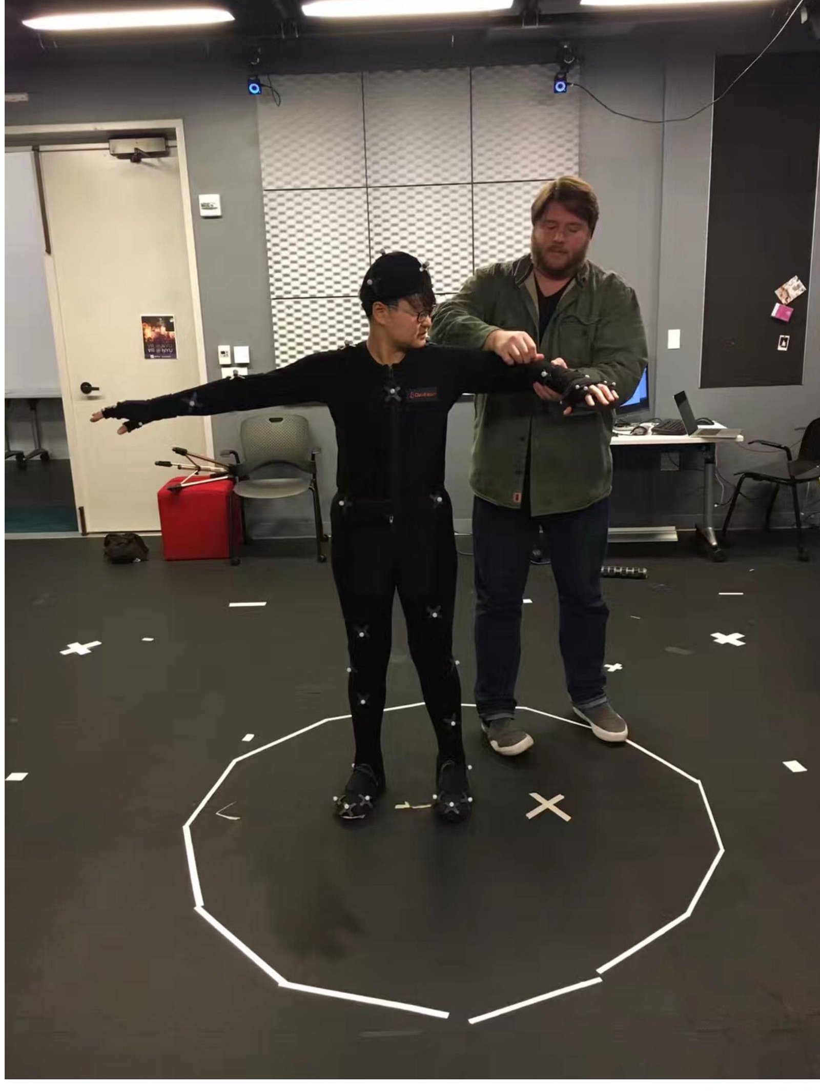 A performer in a motion-capture suit being directed